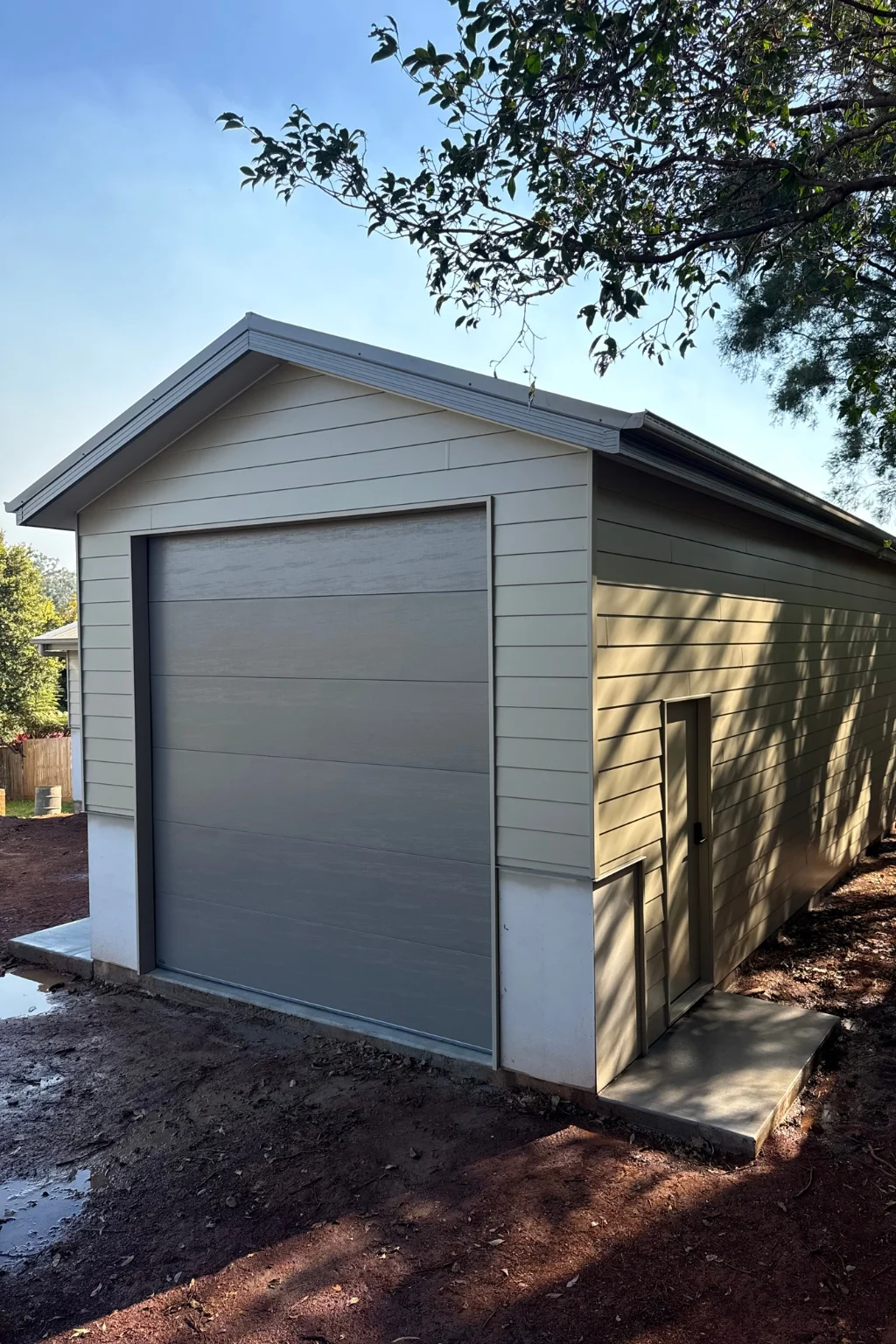 A garage featuring a side door and a large main entrance.