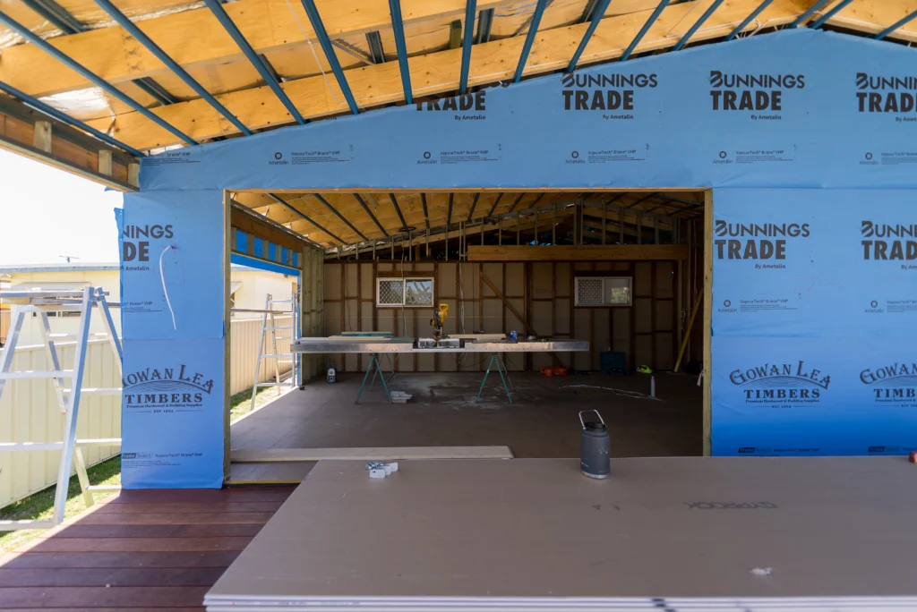 Open plan interior framing and roof structure during a home extension build at Golden Beach, Sunshine Coast by Bozcon Construct