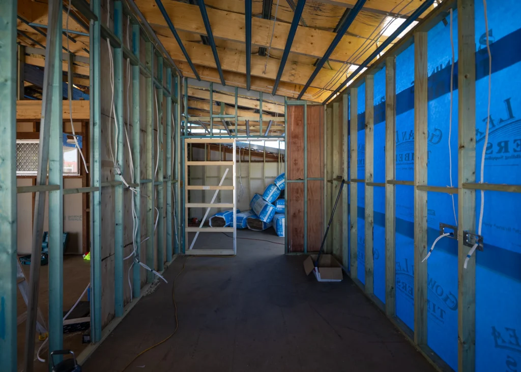 Internal wall framing and insulation installation during a home extension at Golden Beach, Sunshine Coast by Bozcon Construct