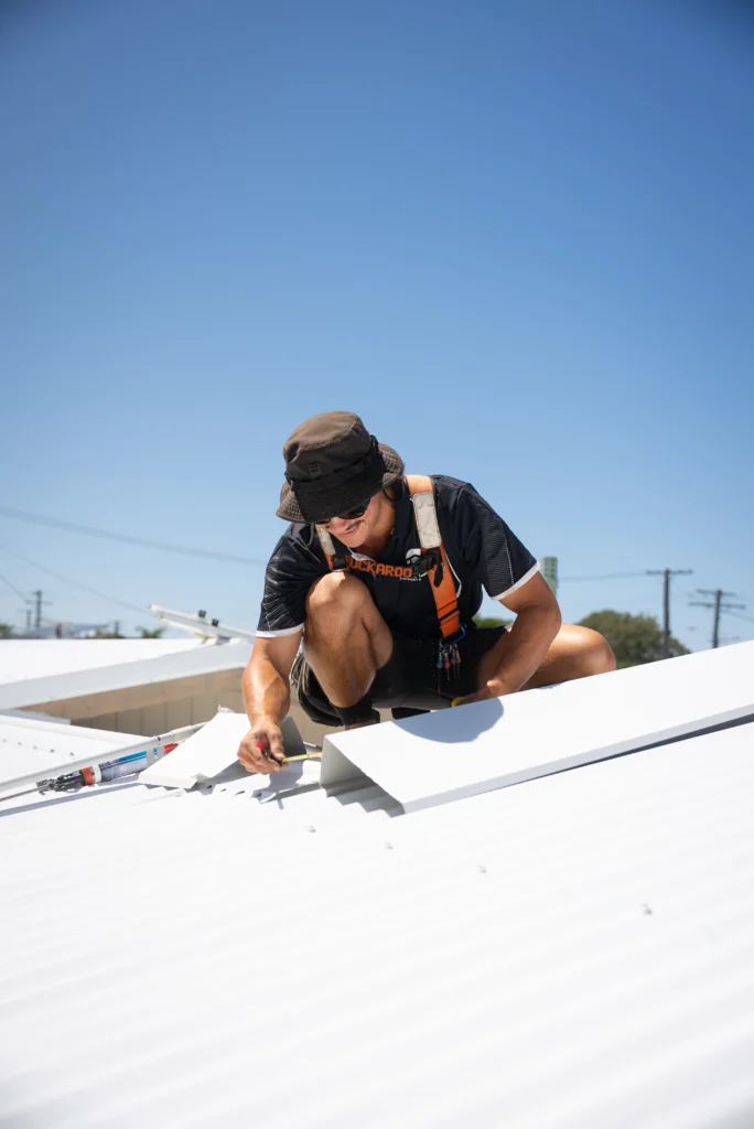 Bozcon Construct tradie installing Colorbond roofing sheets on a new build, Sunshine Coast