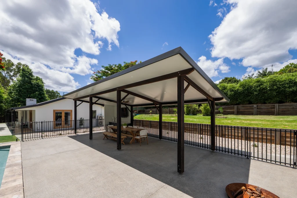 Large covered alfresco entertaining area with insulated panel roof, timber posts, concrete patio and pool surrounds, Sunshine Coast by Bozcon Construct