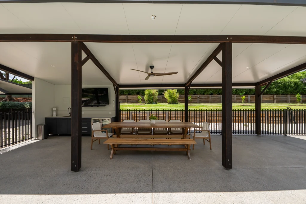 Covered outdoor entertaining area with insulated panel roof, timber posts, ceiling fan and polished concrete, Sunshine Coast by Bozcon Construct