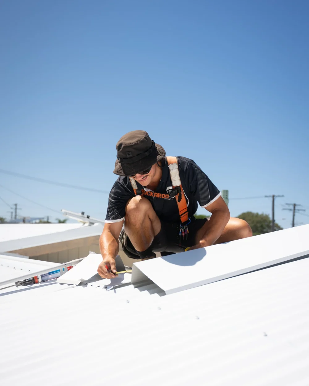 Bozcon Construct tradie installing Colorbond roofing sheets on a new build, Sunshine Coast